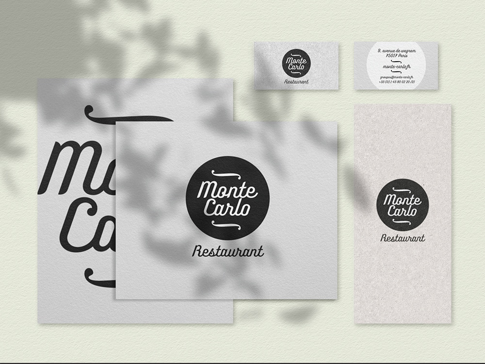 Les supports de marque sophistiqués du restaurant Monte Carlo, conçus par un studio de design talentueux, présentent des cartes de visite et des menus sur un fond vert doux. Limbus Studio